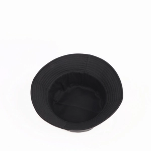 Detail shot of black bucket hat showing reinforced stitching and matte fabric interior
