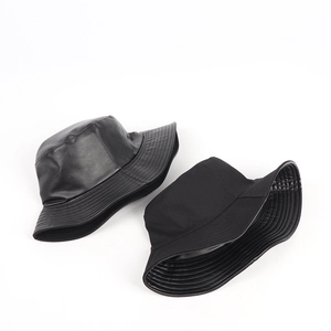 Reversible black PU leather and cotton bucket hats with glossy and matte finishes