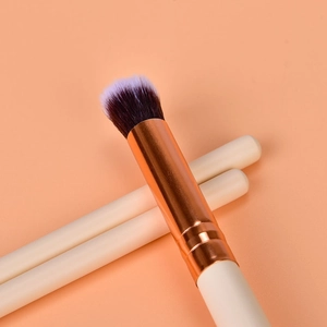 Detailed macro shot of 12 rose gold eye makeup brushes with gradient purple bristles