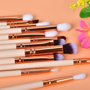 Detail of 12pcs rose gold eyeshadow brushes with soft synthetic bristles and cream handles