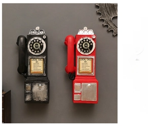 Detail of vintage wall-mounted resin telephone models in black and red classic colors