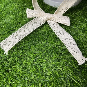Lace strap sun hat with vintage hollow pattern and crochet bow on grass background