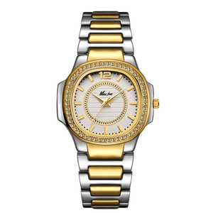 Close-up of luxury gold and silver two-tone diamond-set ladies watch with white textured dial