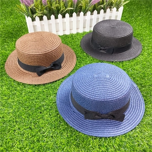 Flat top straw sun hats with black ribbons in brown black and blue colors