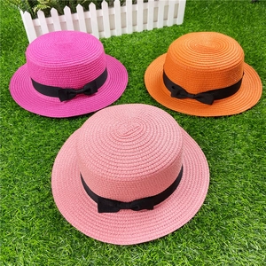 Flat top straw sun hats with black bows in rose, orange, and pink colors