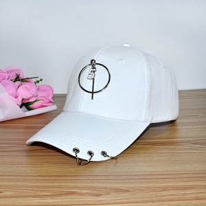 Detailed close-up of white baseball cap with metal rings and number five pendant detail