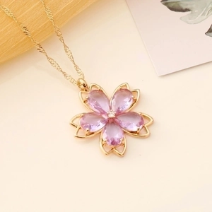 Pink crystal cherry blossom pendant necklace with gold chain and floral design