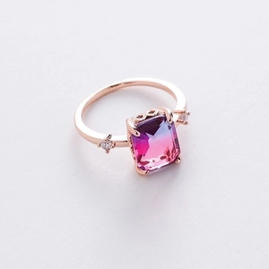 Detail of rose gold ring with a rectangular gradient purple to pink gemstone and accents