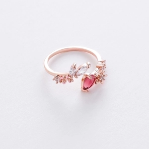 Macro detail of rose gold flower ring with pink pear crystal and leaf zircon accents