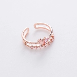 Macro detail of rose gold heart ring with pink zircon pavé and adjustable open band