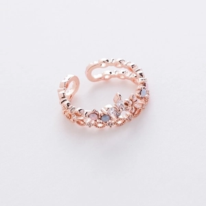 Macro detail of rose gold open ring with micro-paved butterfly and flower motifs