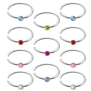 Set of 12 stainless steel nose rings with colorful round crystal gemstones on white background