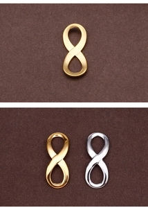 Macro detail of infinity symbol metal connectors in gold and silver finish for DIY jewelry