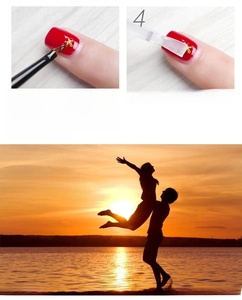 Detailed macro view showing the application of gold star charms on red nail art polish