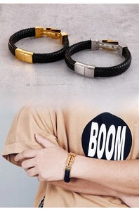 Detail of woven leather bracelet with mechanical metal clasp on model wrist