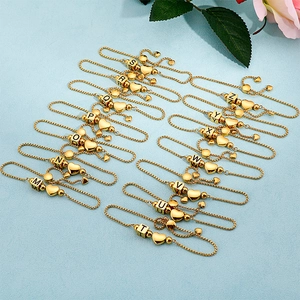 Adjustable gold letter heart bracelet featuring initial charms from M to Z on blue background