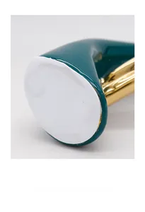 Close-up of ceramic base with emerald glaze and white anti-slip foam padding detail