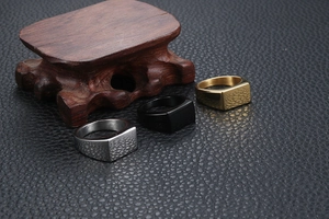Three minimalist rectangular signet rings for men in silver, gold and black on leather