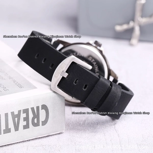 Macro shot of men's skull watch black silicone strap and branded steel buckle