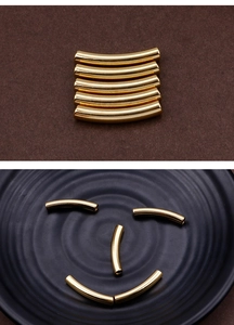 Macro shot of curved 304 stainless steel golden hollow tube charms for DIY jewelry making