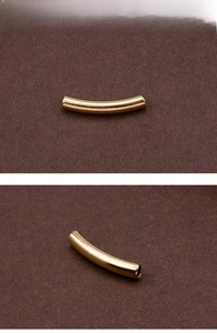 Detailed view of curved golden stainless steel tube charms for DIY jewelry making