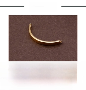 Detailed view of golden stainless steel curved bar pendant with connection rings for jewelry