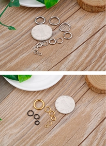 Silver gold and black open rings for DIY jewelry making shown with a reference coin