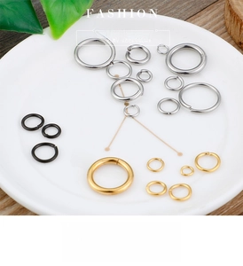 Macro shot of gold, silver, and black titanium steel open jump rings for DIY jewelry