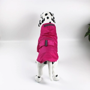 Detail of rose red waterproof dog raincoat with honeycomb texture and reflective strip