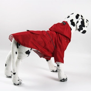 Close-up of waterproof honeycomb fabric and reflective safety strip on a red pet raincoat