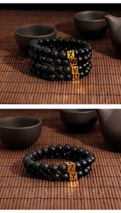 Macro detail of handmade volcano stone bracelets with gold letter beads on a bamboo mat