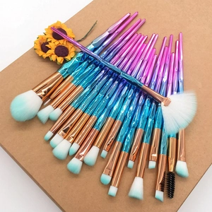 Macro shot of 20-piece makeup brush set with purple gradient handles and dual-tone bristles