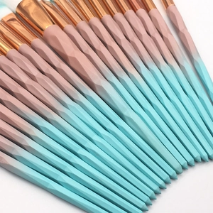 Close-up of 20pcs makeup brushes with pink-blue gradient diamond cut handles and gold ferrules