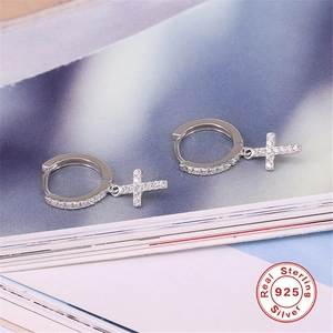Close-up of S925 sterling silver hoop earrings with micro-paved zircon cross pendants
