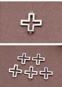 Detailed view of silver hollow cross jewelry connectors with textured dot patterns