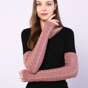 Pink knit fingerless arm warmers with cable pattern shown on a female model
