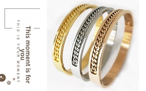 Detailed view of metal bangles in gold silver and rose gold with chain texture inlay
