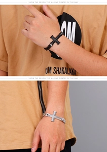 Macro shot of punk style stainless steel cross bracelets in silver and black metal finishes