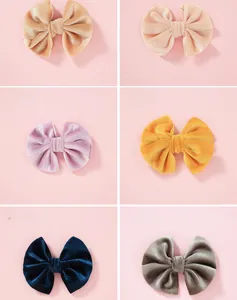 Six colors of soft velvet bow hair clips for girls in a grid display with pastel tones