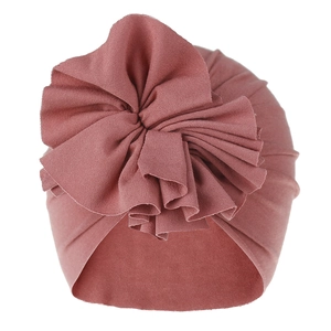 Macro detail view of baby pleated flower turban hat in dusty rose pink soft cotton