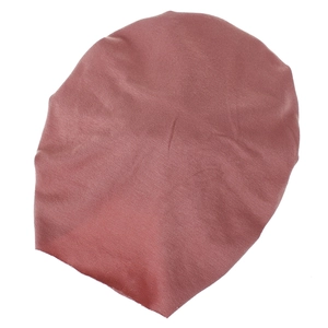Detailed view of dusty pink knitted cotton baby beanie with soft texture and elastic fabric