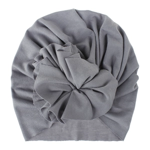 Soft grey knitted cotton baby turban hat featuring an oversized ruffled flower knot