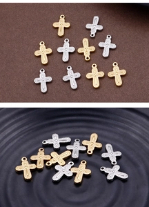 Macro shot of assorted gold and silver metal cross charms for DIY jewelry making
