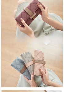 Close-up of elegant long PU leather wallets with embossed floral patterns and metal buckle