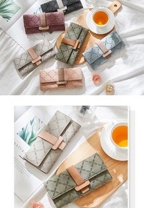 Detailed view of women's long wallets with clover embossing and snap closure in various colors