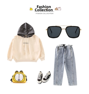 Flat lay of trendy kids fashion set with black square sunglasses and cat ear hoodie