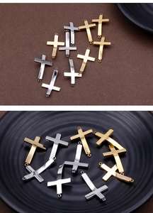 Detailed view of silver and gold cross charms for DIY jewelry making on textured backdrops