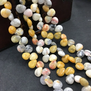 Macro shot of natural teardrop agate beads in yellow and grey for DIY jewelry making