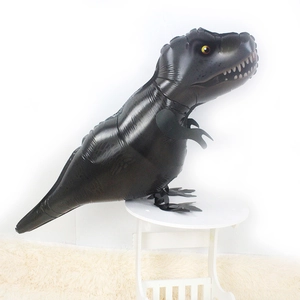 Black T-Rex dinosaur foil balloon standing on a small stool for birthday party decor