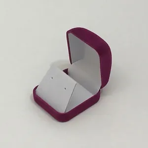 Macro shot of purple velvet jewelry box with white insert for stud earrings display